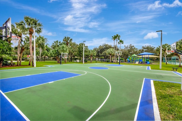 view of sport court with a playground and a yard