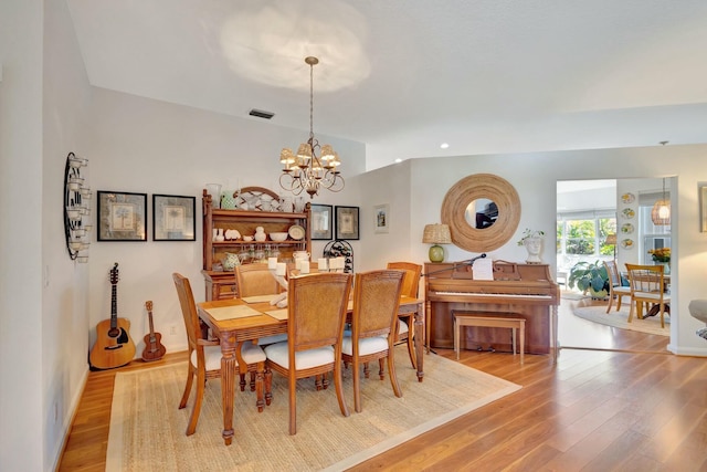 dining room featuring a chandelier and light hardwood / wood-style flooring