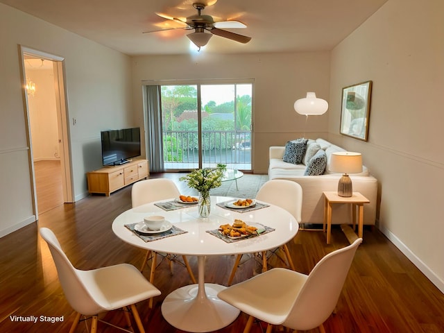 dining space with dark hardwood / wood-style floors and ceiling fan