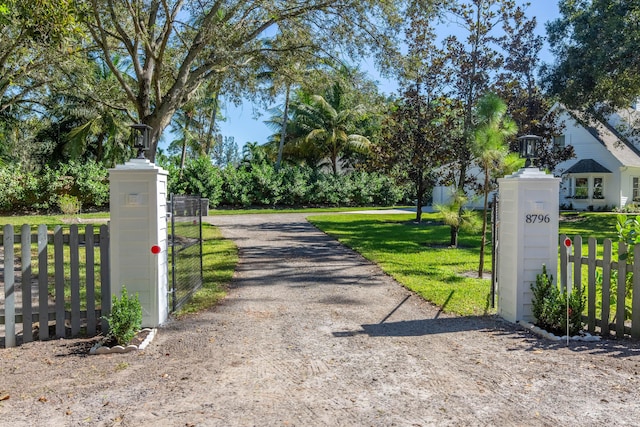 view of gate featuring a yard