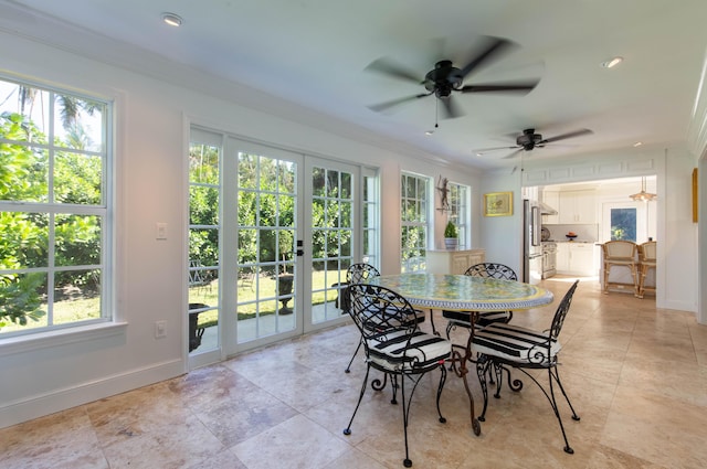 dining room featuring ceiling fan, plenty of natural light, french doors, and ornamental molding