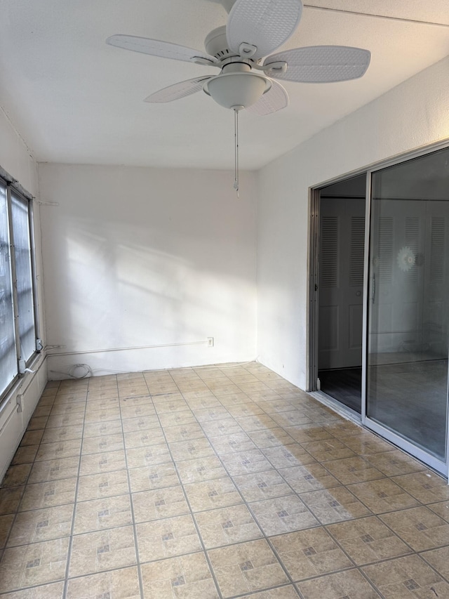 unfurnished sunroom featuring a ceiling fan