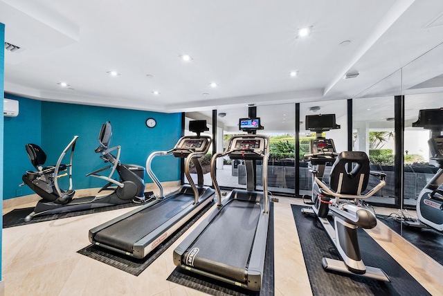 workout area with floor to ceiling windows, light tile patterned flooring, and an AC wall unit