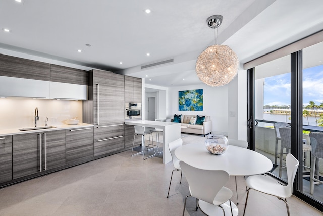 dining room featuring a water view and sink