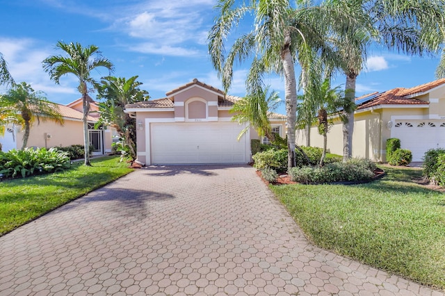 mediterranean / spanish house featuring a garage and a front yard