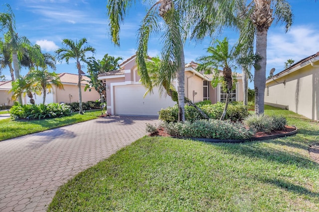 view of front of property featuring a front yard and a garage