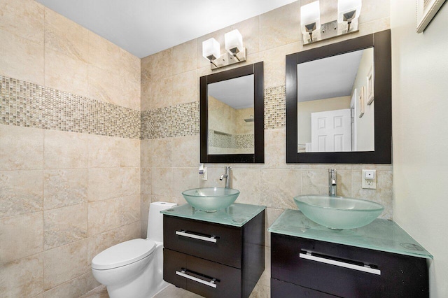 bathroom featuring decorative backsplash, toilet, tile walls, and vanity