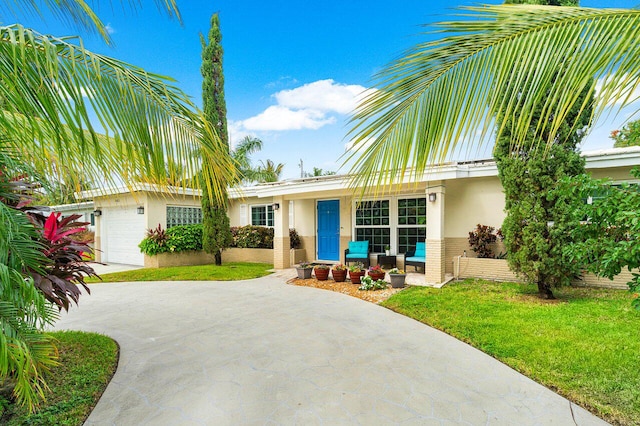 view of front of home with a front lawn and a garage