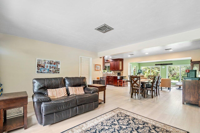 living room with light hardwood / wood-style flooring