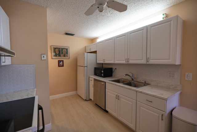 kitchen with stove, sink, stainless steel dishwasher, light wood-type flooring, and white cabinetry