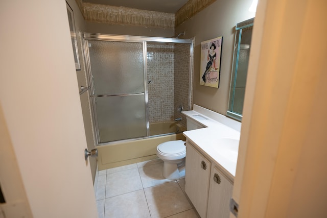 full bathroom with tile patterned flooring, vanity, toilet, and shower / bath combination with glass door