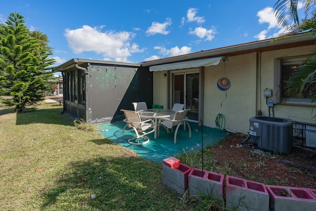 rear view of property with a yard and cooling unit