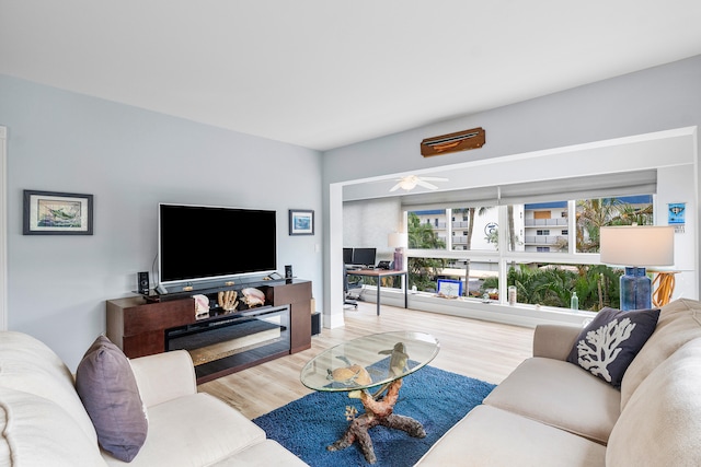 living room featuring hardwood / wood-style floors and ceiling fan