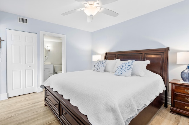 bedroom with ensuite bath, ceiling fan, a closet, and light wood-type flooring