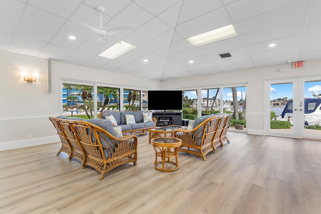 living room featuring french doors, a paneled ceiling, light hardwood / wood-style flooring, and ceiling fan