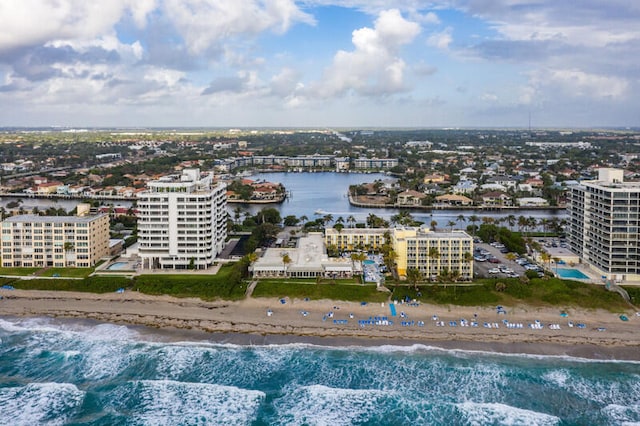 birds eye view of property featuring a beach view and a water view