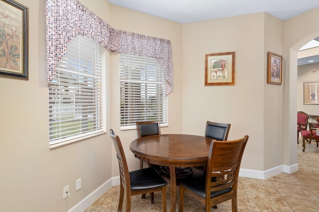 dining space featuring light tile patterned floors