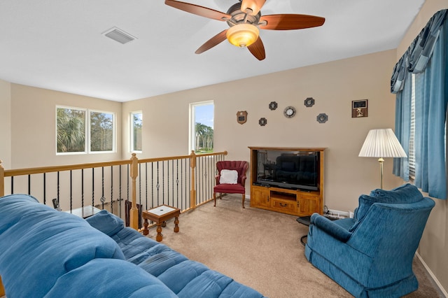 carpeted living room featuring ceiling fan and plenty of natural light