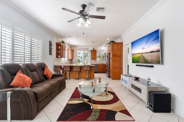 tiled living room featuring ceiling fan and ornamental molding