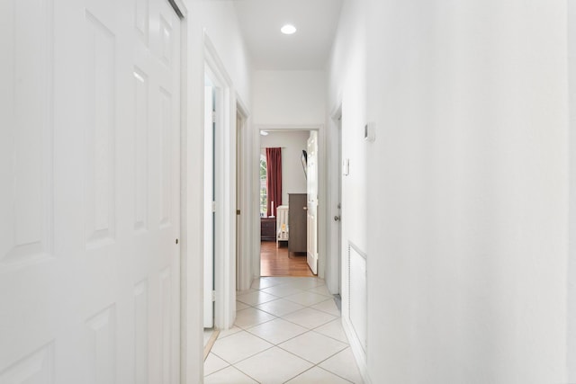 corridor featuring light tile patterned floors