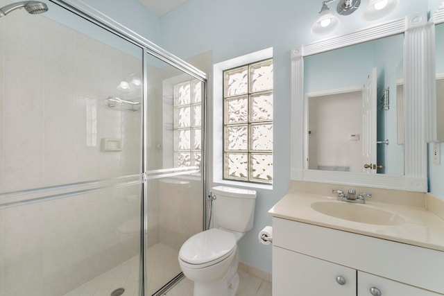 bathroom with vanity, toilet, and walk in shower