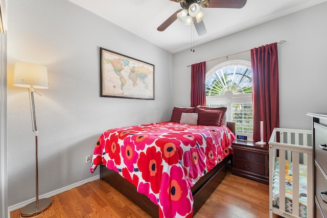 bedroom featuring hardwood / wood-style flooring and ceiling fan