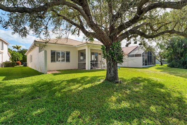 rear view of property featuring a yard