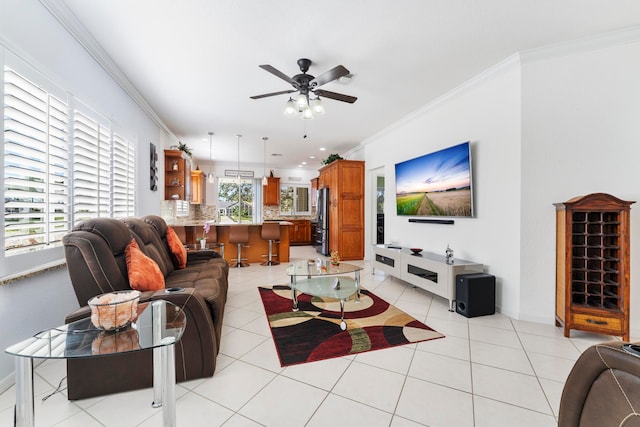 living room with ceiling fan, light tile patterned flooring, and crown molding