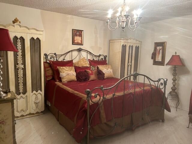 bedroom featuring a chandelier and a textured ceiling