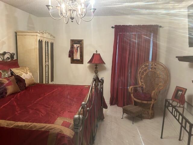 bedroom featuring a textured ceiling and a notable chandelier