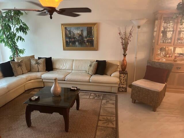 carpeted living room with ceiling fan