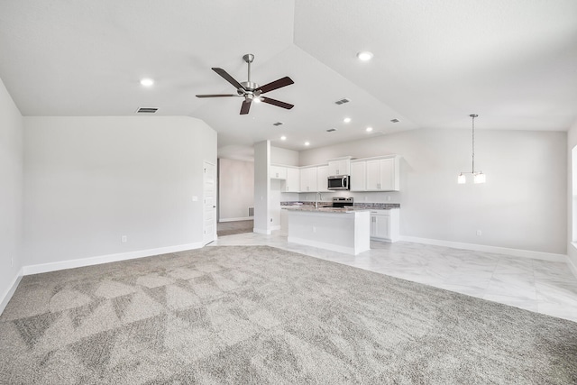 unfurnished living room with light carpet, ceiling fan, and lofted ceiling