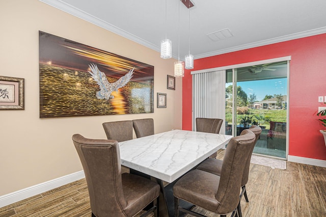 dining space with dark hardwood / wood-style floors and crown molding