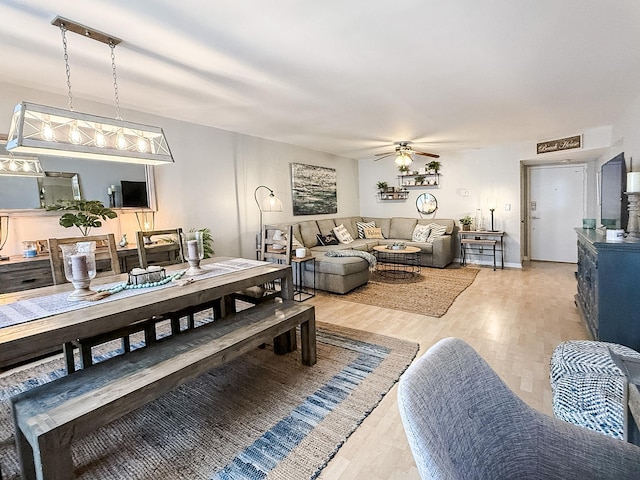 dining space featuring light hardwood / wood-style flooring and ceiling fan