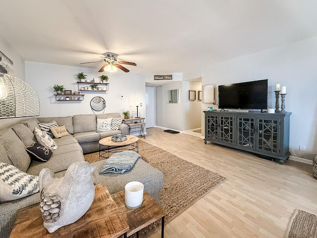 living room featuring hardwood / wood-style flooring and ceiling fan