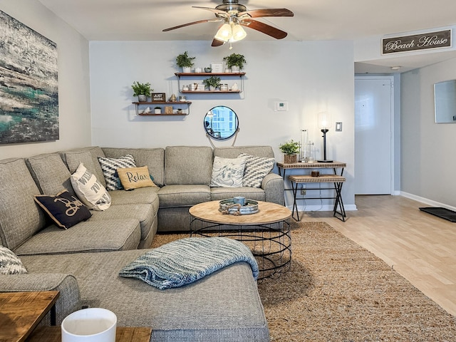 living room featuring hardwood / wood-style floors and ceiling fan