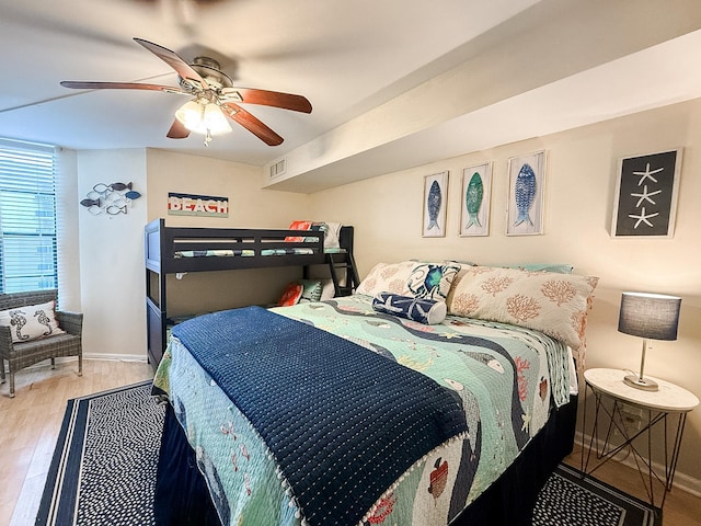 bedroom with ceiling fan and light wood-type flooring