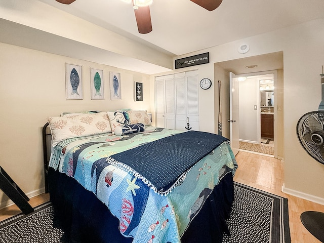 bedroom featuring a closet, light hardwood / wood-style flooring, and ceiling fan