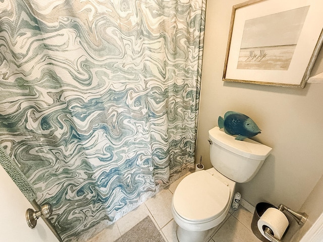 bathroom with tile patterned flooring and toilet