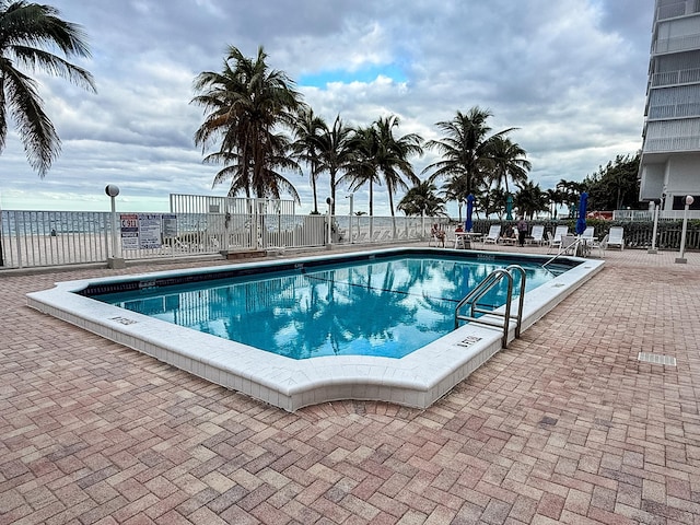 view of swimming pool with a patio