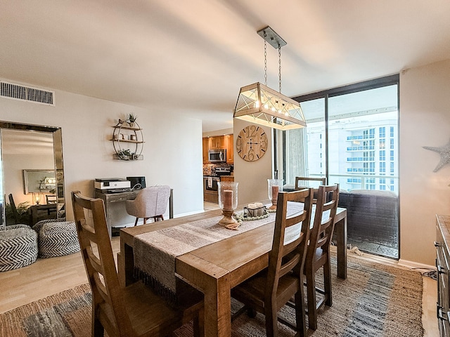 dining space with light hardwood / wood-style flooring