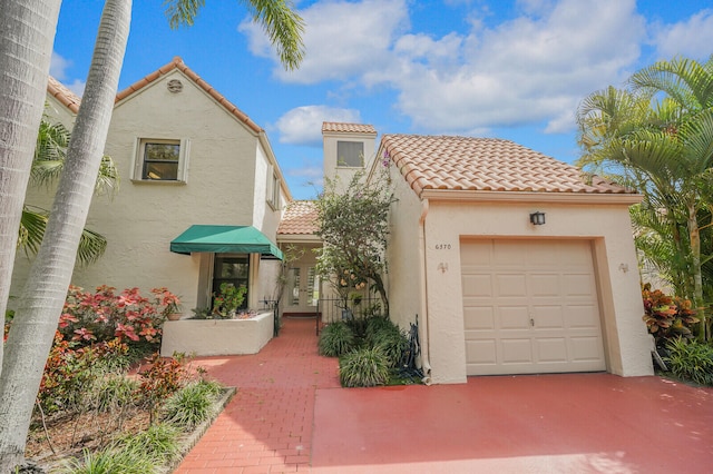 mediterranean / spanish-style house with a garage