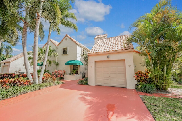 mediterranean / spanish-style home featuring a garage