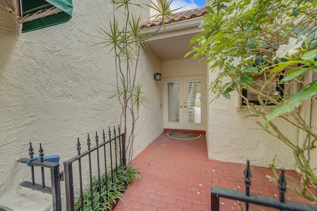 view of exterior entry featuring french doors