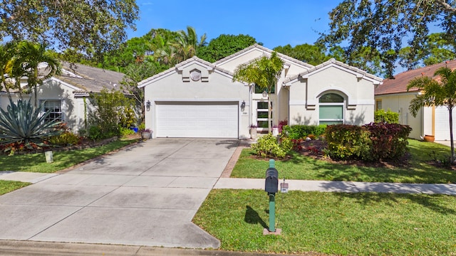 view of front of property featuring a garage and a front yard