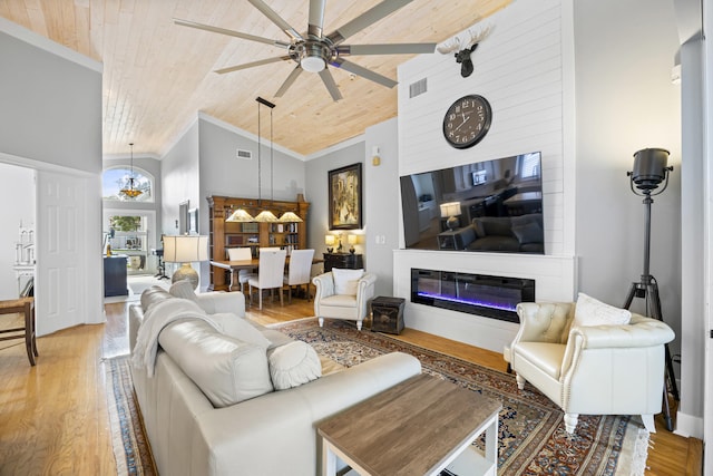 living room featuring ornamental molding, ceiling fan, high vaulted ceiling, wooden ceiling, and hardwood / wood-style floors