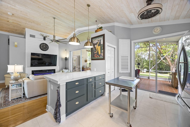 kitchen featuring vaulted ceiling, ceiling fan, light wood-type flooring, decorative light fixtures, and wood ceiling