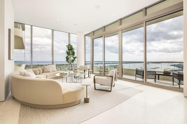 sunroom / solarium with a healthy amount of sunlight and a water view