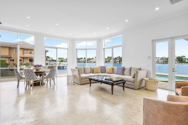 living room with french doors, a water view, and ornamental molding