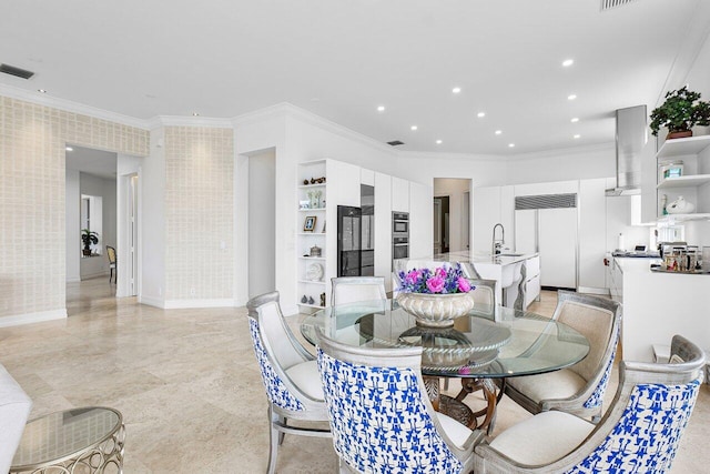 dining room featuring built in shelves and ornamental molding